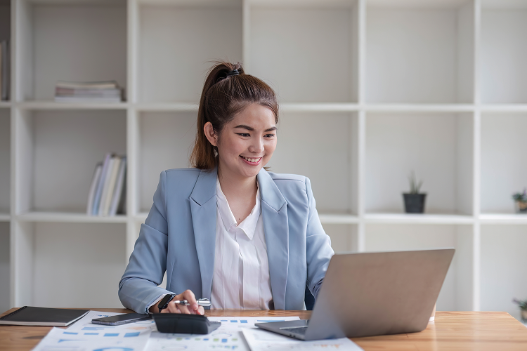 asian-businesswoman-use-laptop-computer-office-internal-revenue-service-audit-document-balance-calculation-report-is-being-prepared 1