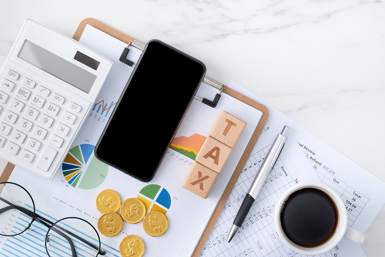 top-view-reading-overview-calculating-paying-tax-with-smart-phone-from-internet 1